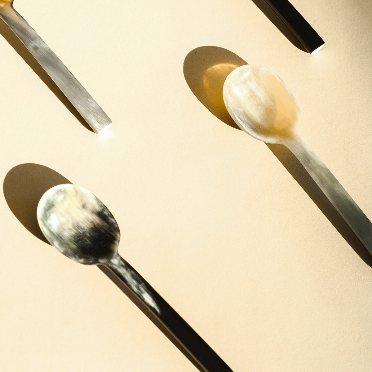 marbled horn spoons laid out on a table